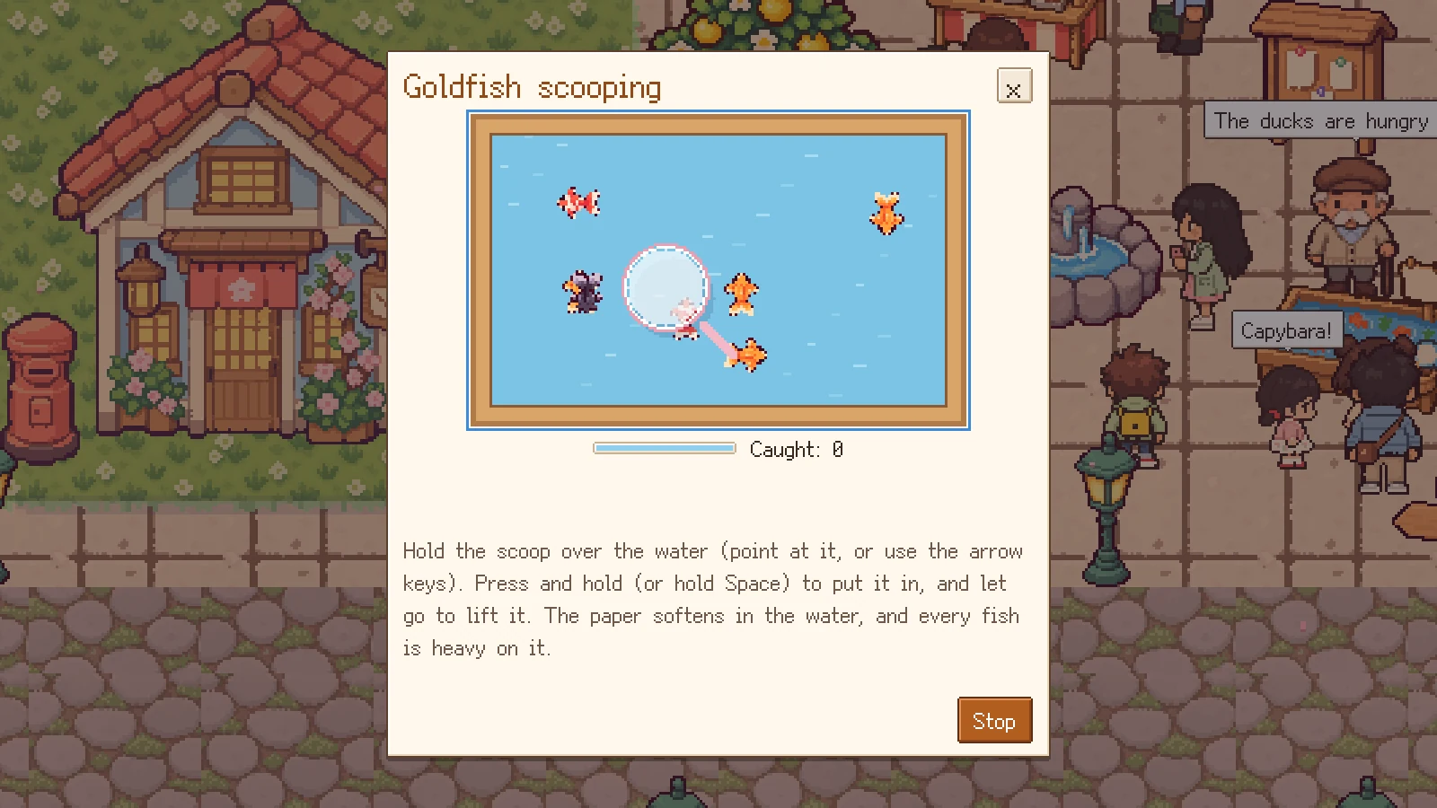 The goldfish-scooping mini-game: a paper scoop over a tank of goldfish